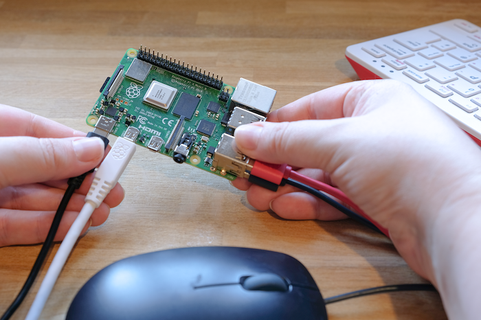 Attaching the power supply to a Raspberry Pi.