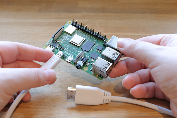 Plugging a micro HDMI cable into a Raspberry Pi.