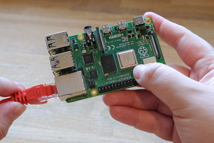 Plugging an Ethernet cable into a Raspberry Pi.